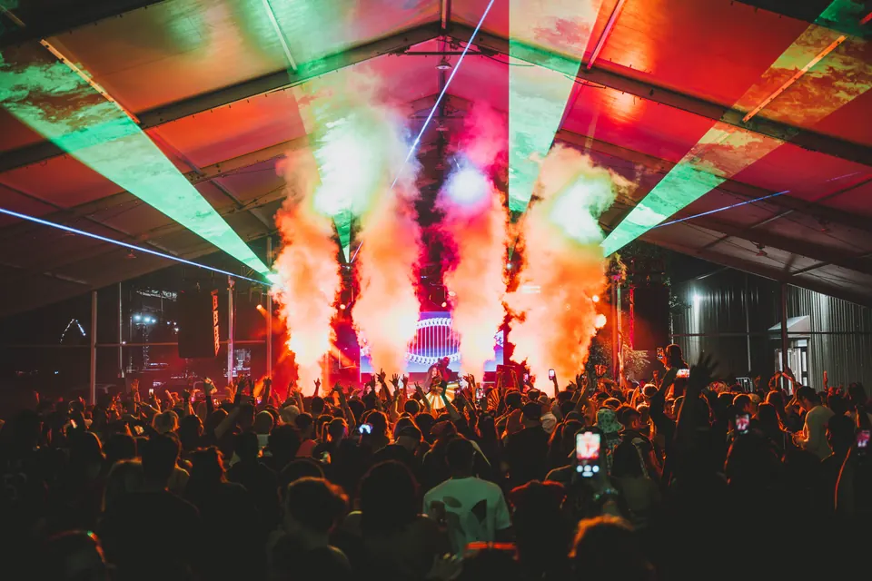 Green lasers and CO2 jets over a packed crowd under the main tent